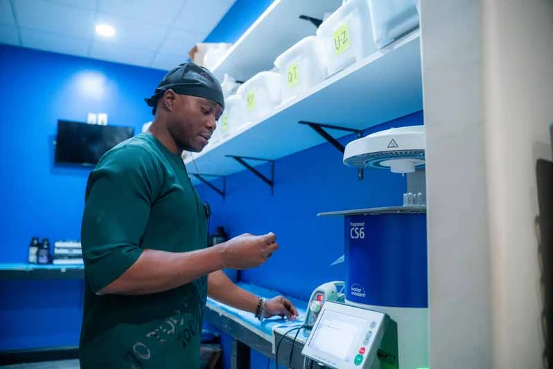 Dr. Abazie crafting a dental implant at 10 Day Smiles