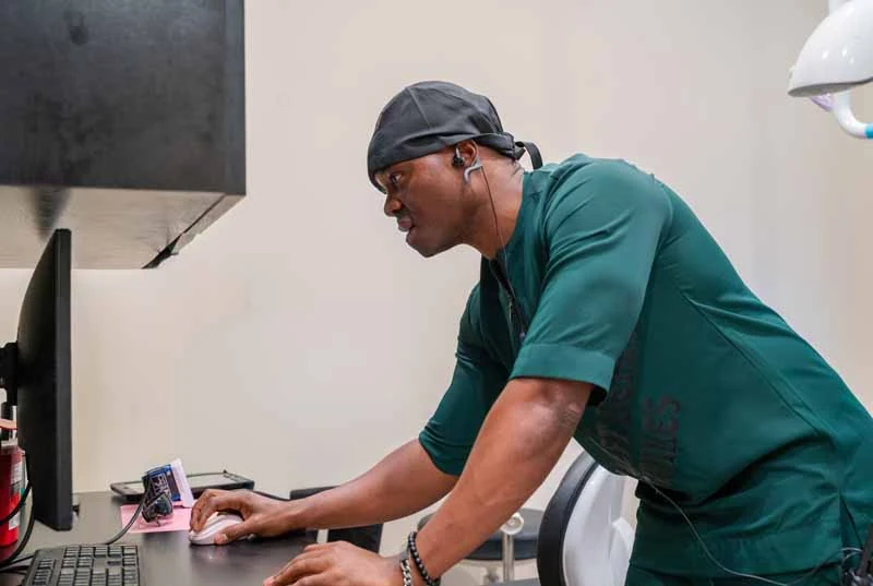 Dr. Abazie reviewing an emergency patients X-rays