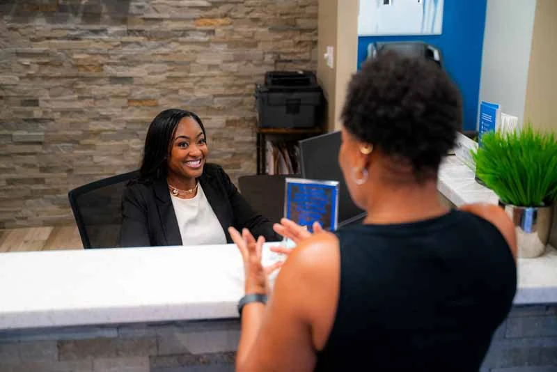 woman scheduling her next dental appointment at 10 Day Smiles