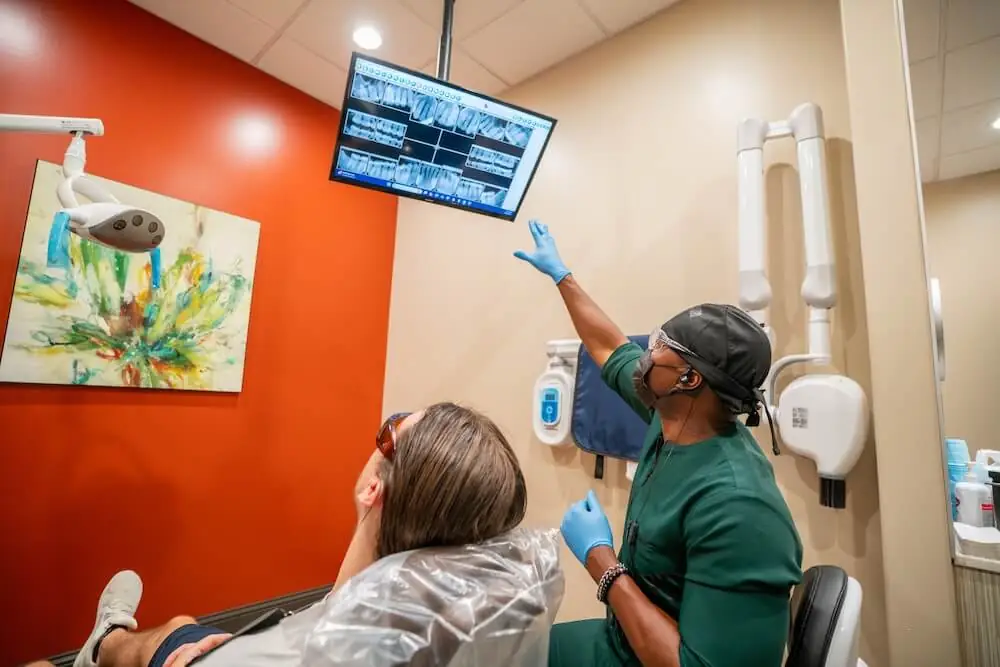 Dr. Abazie reviewing a patient's dental X-rays at 10 day smiles.